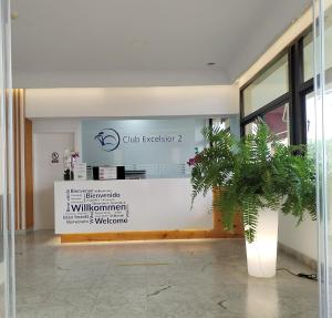 a lobby of a building with a potted plant at Club Excelsior II in Playa del Ingles