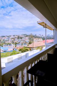 a balcony with a view of a city at Lao Tangren Guest House in Kigali
