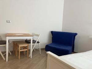 1 dormitorio con una silla azul y una mesa en Cristallo di neve b&b en Roccaraso