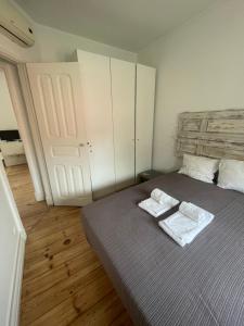 a bedroom with a bed with two towels on it at Penha Cozy Home in Lisbon