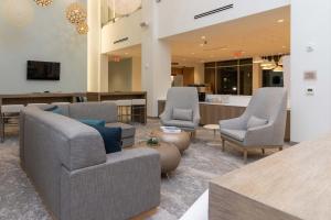 a lobby with three chairs and a reception desk at Element St. Louis Midtown in Saint Louis
