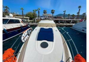 a white boat is docked in the water at Bodrum Yacht Rental in Yalikavak in Bodrum City
