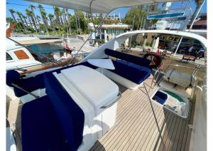 a boat with blue chairs on a wooden deck at Bodrum Yacht Rental in Yalikavak in Bodrum City