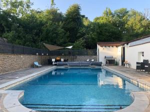 a swimming pool with blue water in a backyard at Glamorgan House in Cardiff