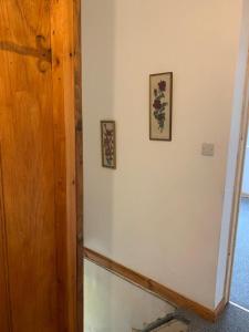 a room with two pictures on the wall and a door at One Lovely Apartmt 1 Double & 2 Camp Beds in Stoke on Trent