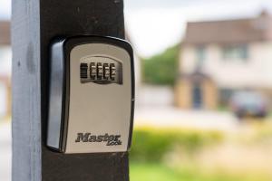 a cell phone is attached to a wooden post at Nr WINDSOR stunning 1 bedroom self contained property in Burnham near Heathrow in Burnham