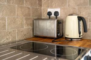 a toaster sitting on top of a kitchen counter at Nr WINDSOR stunning 1 bedroom self contained property in Burnham near Heathrow in Burnham
