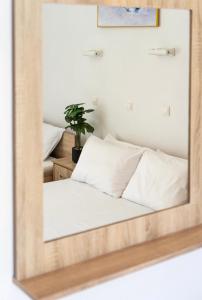 a mirror reflecting a bed in a bedroom at Villa Elva in Ammoudia