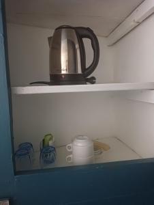 a tea kettle is sitting on top of a shelf at Marie-Claire la grillade in Briare