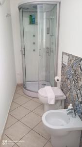 a bathroom with a shower and a toilet and a sink at CAMERE LA COMETA in Marsala