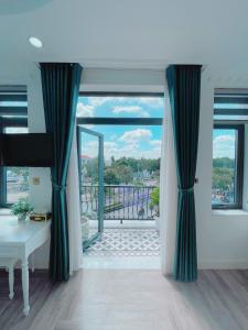 a living room with a view of a balcony at Paris Hotel & Cafe in Vĩnh Long