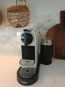 a toaster sitting on a counter next to a cup at Gemütliches Appartement im Kottenforst Nähe Bonn in Meckenheim +16 photos
