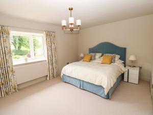 a bedroom with a bed and a window at Llety'r Bugail in Aberdare