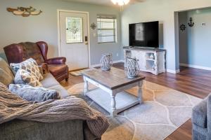 a living room with a couch and a coffee table at Cookson Vacation Rental with Spacious Yard and Porch! in Cookson