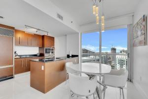 a kitchen with a table and chairs and a large window at PENTHOUSE 2BR ICON WHOTEL Brickell Miami in Miami