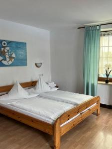 a bed in a bedroom with a blue curtain at Aal-Kate in Wuppertal