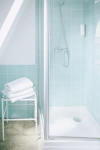 a bathroom with a shower with a glass door at Penzion Na Staré Poště in Nymburk