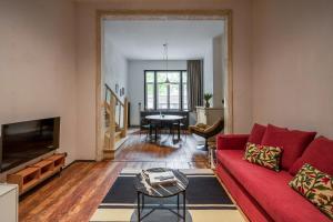 a living room with a red couch and a table at Smartflats - the Brooklyn Antwerp in Antwerp