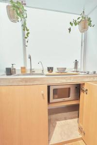 a kitchen with a sink and a microwave at Cozy Mini Loft Close To Angel De La Independencia in Mexico City