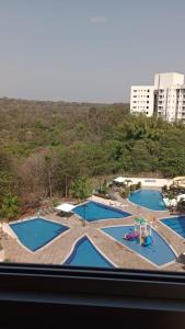 a view of three pools from a window at Park Veredas in Rio Quente
