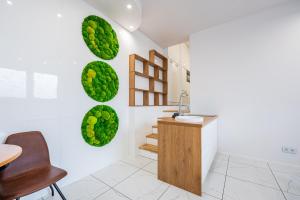 a bathroom with green spheres on the wall at BioKompas SPA Apartment in Wrocław