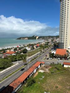a view of a city with the ocean and buildings at Flat Praia de PontaNegra - Natal RN in Natal
