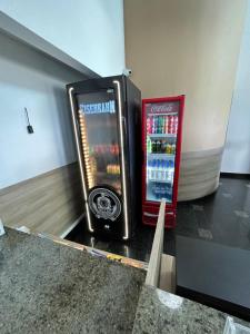 two soda machines are sitting in a room at PONTA NEeGRA FLAT - HOTEL MILOR in Natal