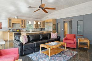 富丽海滩Folly Vacation 620 Entire Home plus Apt, one block to the beach and pet friendly的客厅里有一张黑色沙发和一张桌子