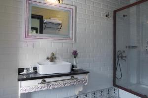 a white bathroom with a sink and a mirror at Bursa İpekyolu Hotel in Bursa