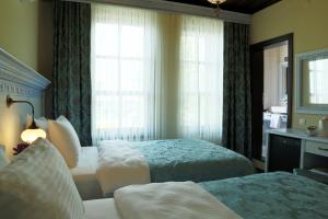 Postel nebo postele na pokoji v ubytování Bursa İpekyolu Hotel