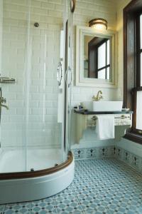a bathroom with a shower and a tub and a sink at Bursa İpekyolu Hotel in Bursa
