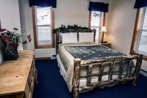 a bedroom with a large bed with a wooden frame at Timber Creek Chalets- 8 chalet in Estes Park