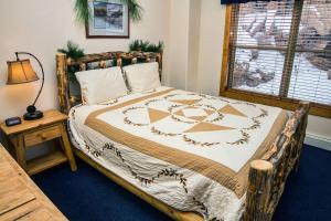 a bedroom with a large bed with a wooden frame at Timber Creek Chalets- 8 chalet in Estes Park