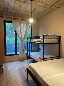 a bedroom with two bunk beds and a window at The Best House in Ureki