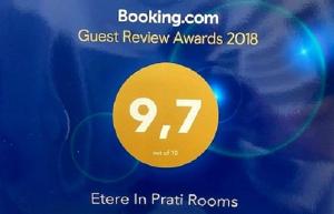 a sign that says guest review awards with a yellow circle at Etere in Prati Rooms in Rome