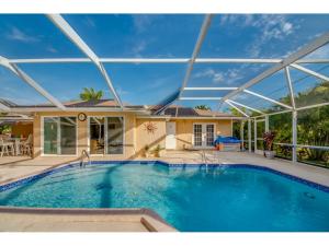 a large swimming pool in front of a house at Villa Hideaway, Cape Coral in Cape Coral