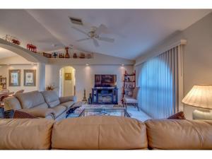a living room with a couch and a table at Villa Hideaway, Cape Coral in Cape Coral