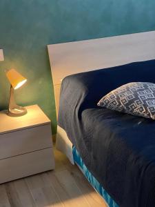 a bedroom with a bed and a lamp on a night stand at B&B Tirassegno in Agnone