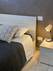 a bedroom with a bed and a lamp on a nightstand at B&B Tirassegno in Agnone