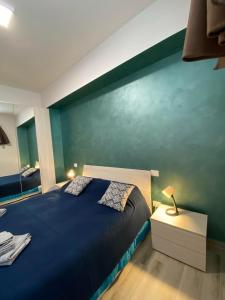 アニョーネにあるB&B Tirassegnoの青い壁のベッドルーム1室、ベッド1台が備わります。