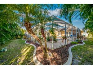 a palm tree in front of a house at Villa Hideaway, Cape Coral in Cape Coral