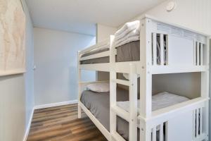 a white bunk bed in a small room with wooden floors at Kimberling City Escape with Dock Access and Boat Slips in Kimberling City +19 photos