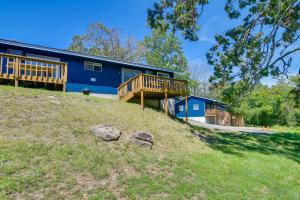 a blue house with a deck on a hill at Kimberling City Cabin with Schooner Creek Access! in Kimberling City