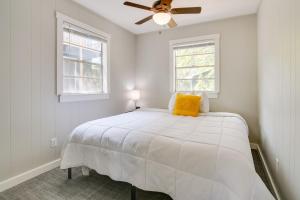 a white bedroom with a bed and a ceiling fan at Tranquil Kimberling City Getaway with Community Pool in Kimberling City