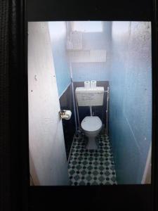 a small bathroom with a toilet in a stall at Karen's breakaway spot. in Leysdown-on-Sea