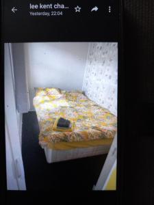 a picture of a bed with a cell phone on it at Karen's breakaway spot. in Leysdown-on-Sea