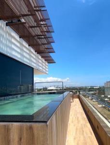 a swimming pool on the roof of a building at Brand new, with private Jacuzzi in Carlos Guerra