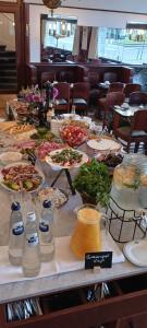 a table with plates of food and bottles of milk at Hotel Du Parc in Ostend
