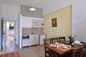 a kitchen and dining room with a table and chairs at Arlen Beach Hotel in Hersonissos