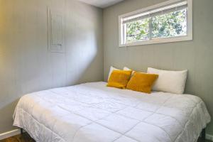 um quarto com uma cama branca e 2 almofadas amarelas em Lakefront Escape with Boat Slip on Table Rock Lake! em Kimberling City